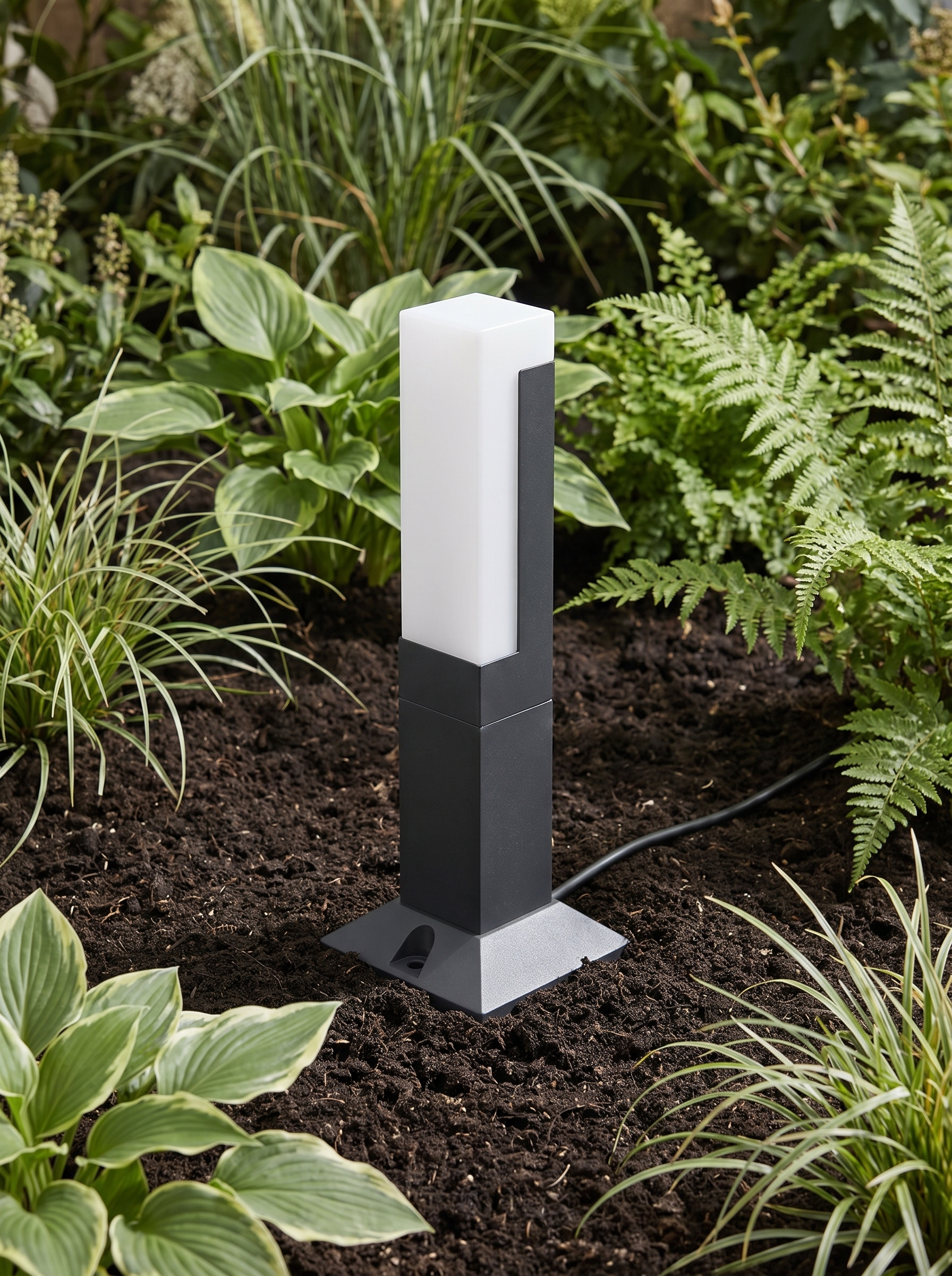 Meadow path light spike set into a border